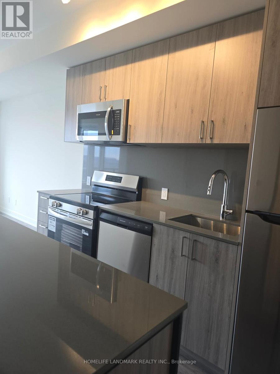 A modern kitchen with a stainless steel sink and microwave.