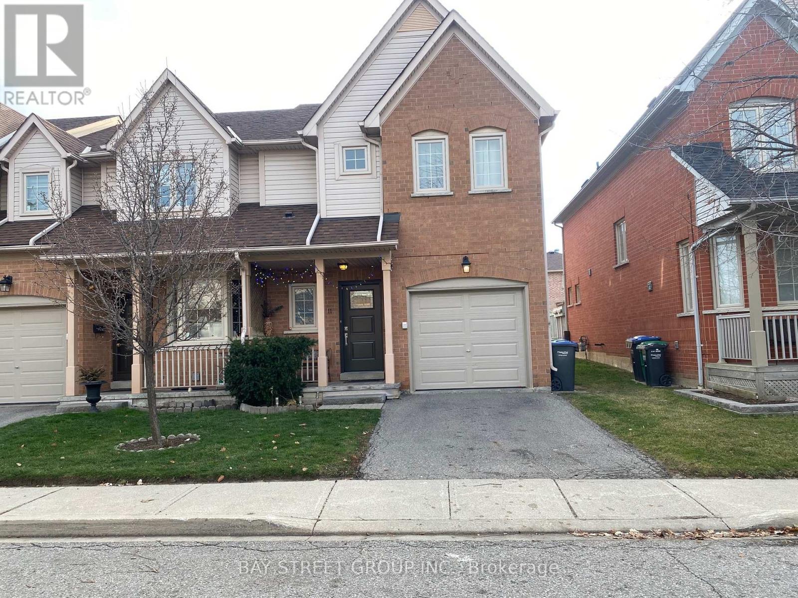 A two-story house with a garage is for sale.
