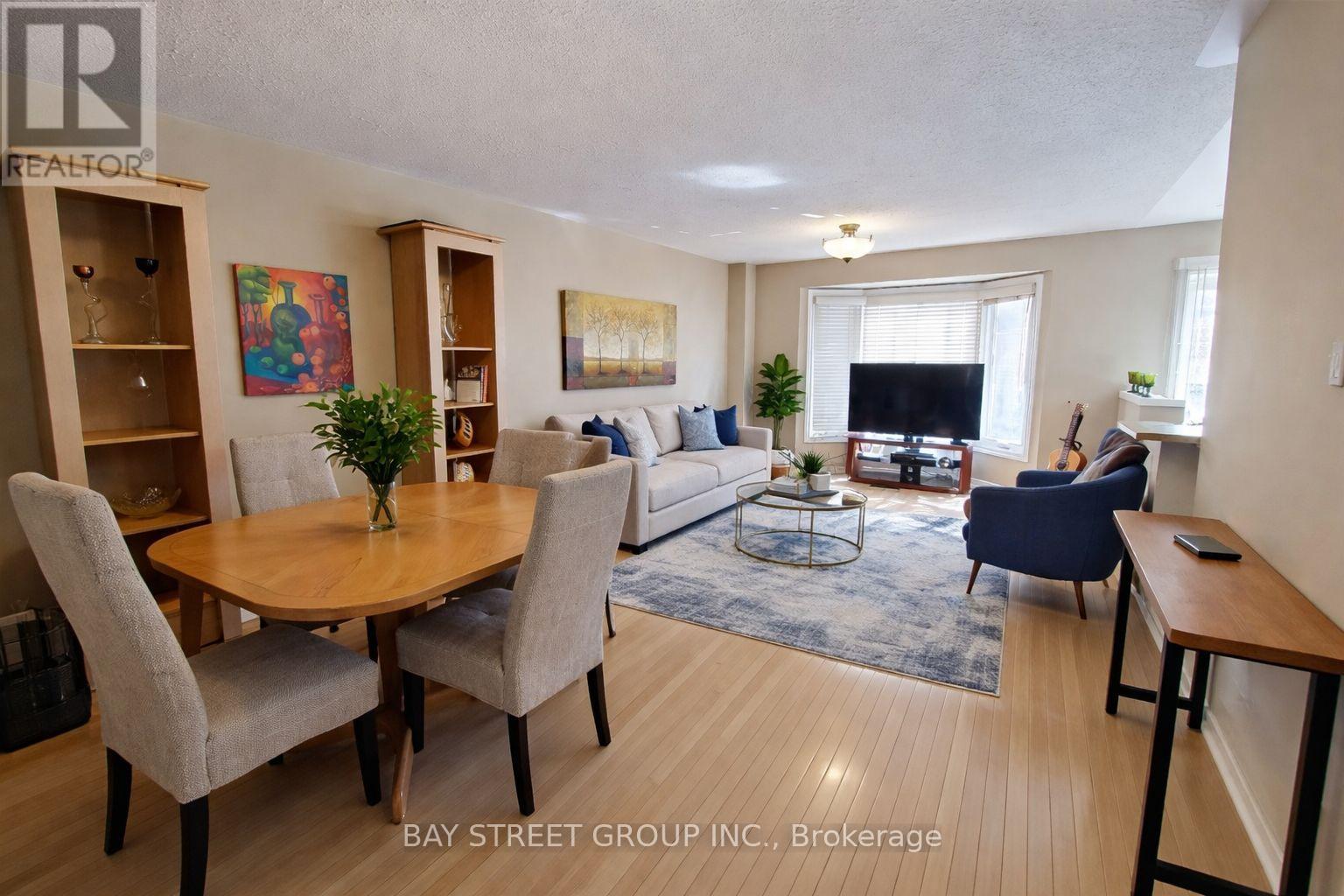 A living room with a dining table and chairs.