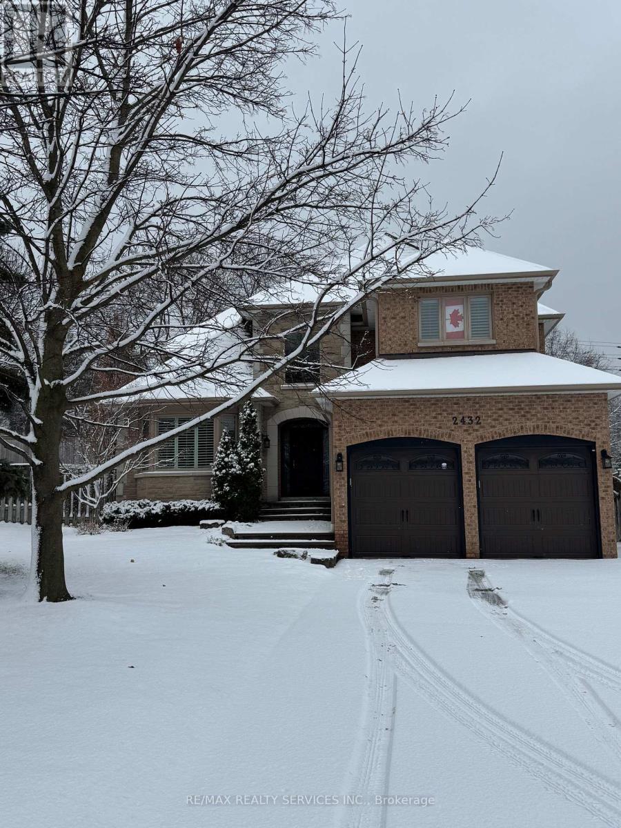 A house with a snow-covered front yard and a flag on the front.