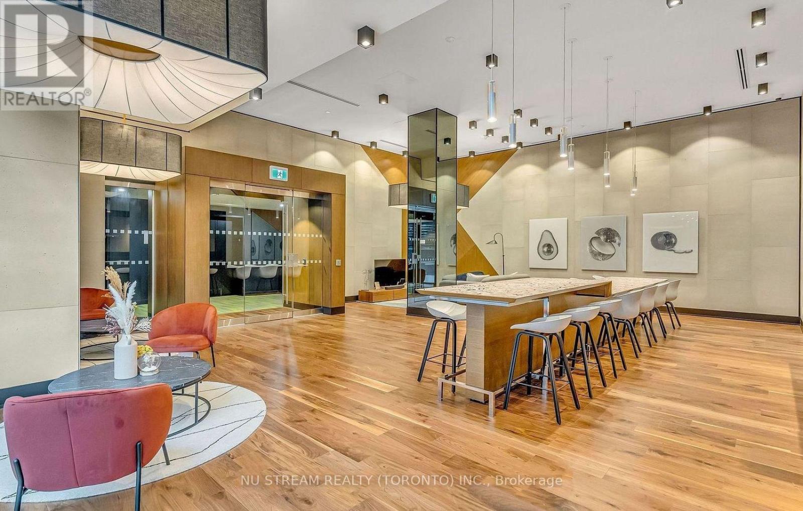 A modern dining area with a long table and chairs.