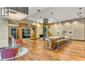 A modern dining area with a long table and chairs.