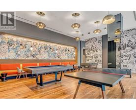 A room with a pool table and a mural on the wall.