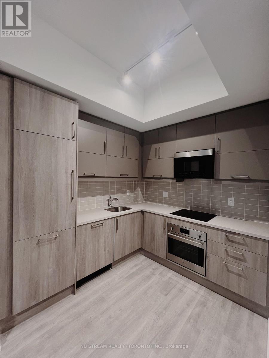 A modern kitchen with wooden cabinets and a stainless steel oven.