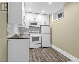 A kitchen with white appliances and a granite countertop.