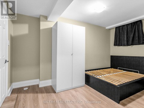 A bedroom with a bed, wardrobe and cupboard.