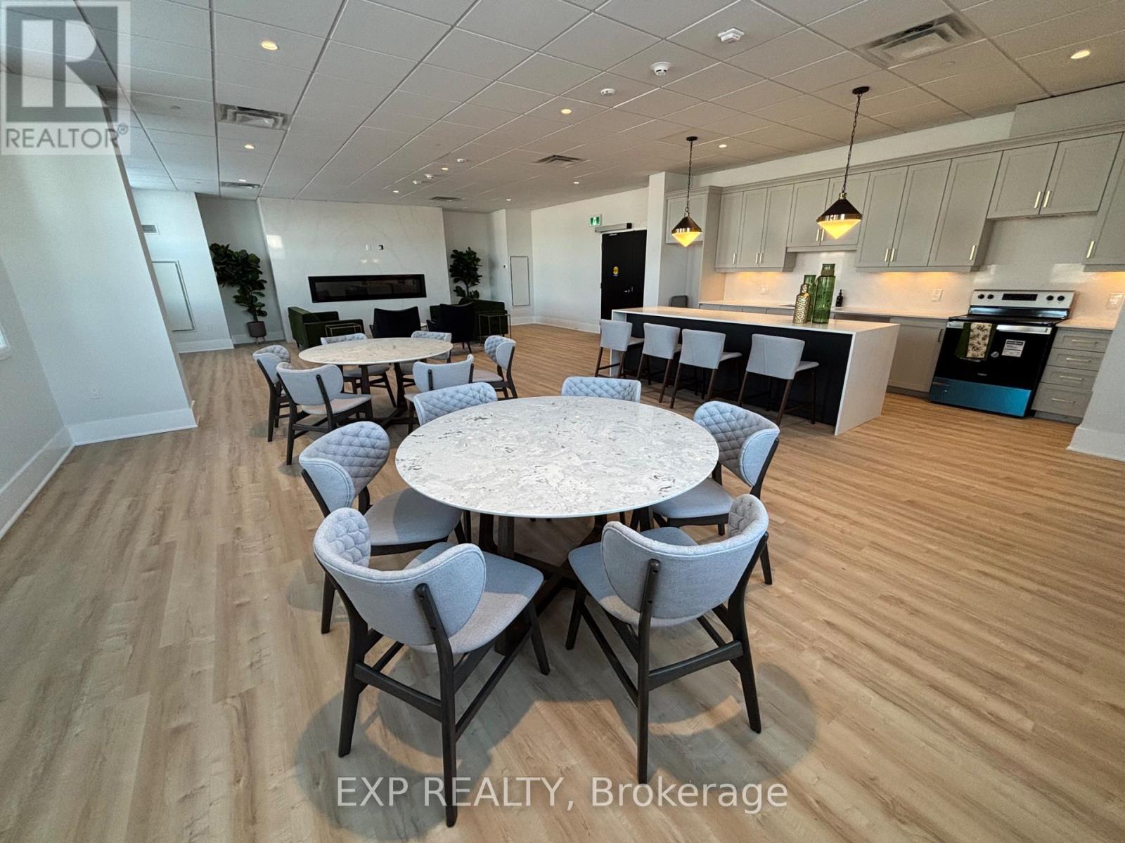 A dining room with a round table and chairs.