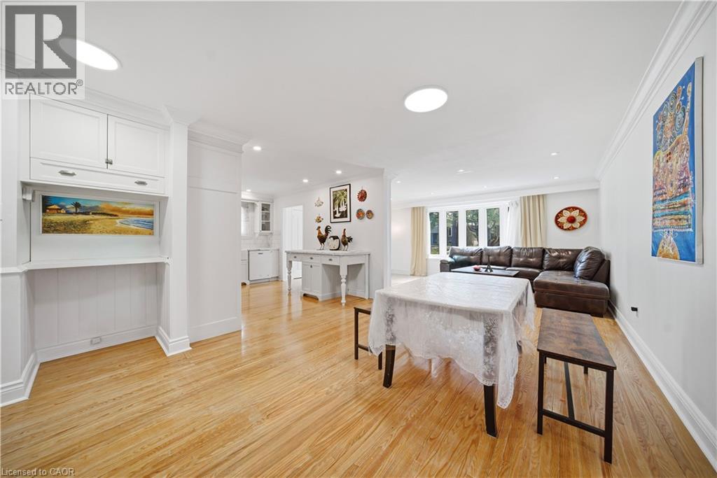 A dining room with a white table and chairs.