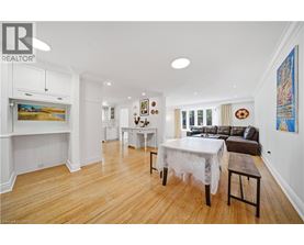 A dining room with a white table and chairs.