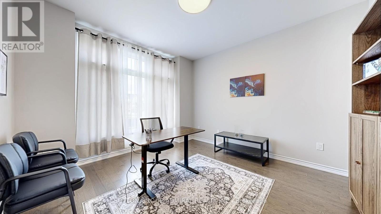 A living room with a black chair and a small table.