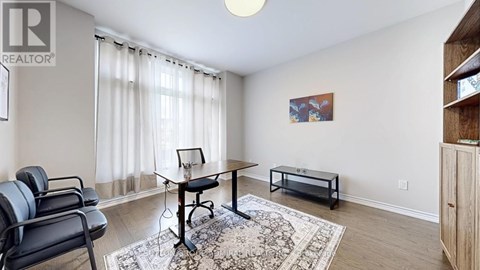 A living room with a black chair and a small table.