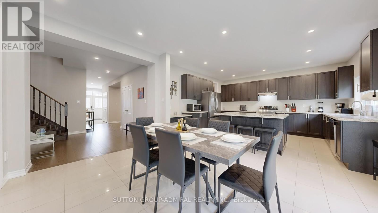 A modern kitchen with a dining table and chairs.