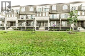 A grassy area in front of apartment buildings.