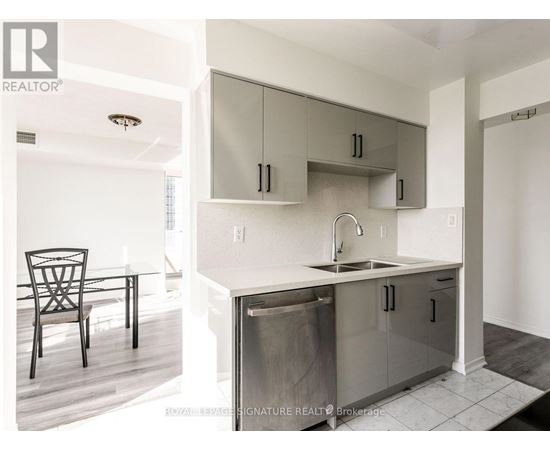 A modern kitchen with a sink and a dishwasher.