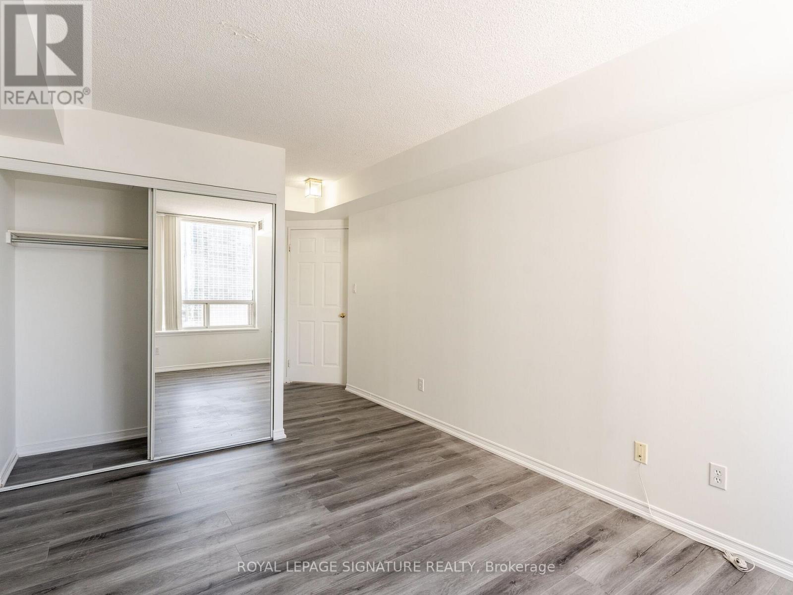 A spacious room with a sliding door and a window.