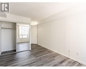 A spacious room with a sliding door and a window.