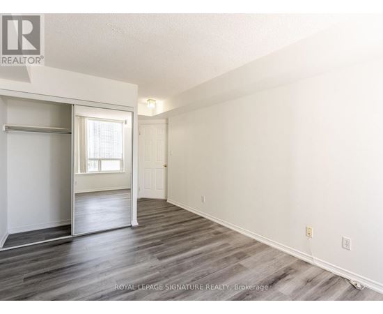 A spacious room with a sliding door and a window.