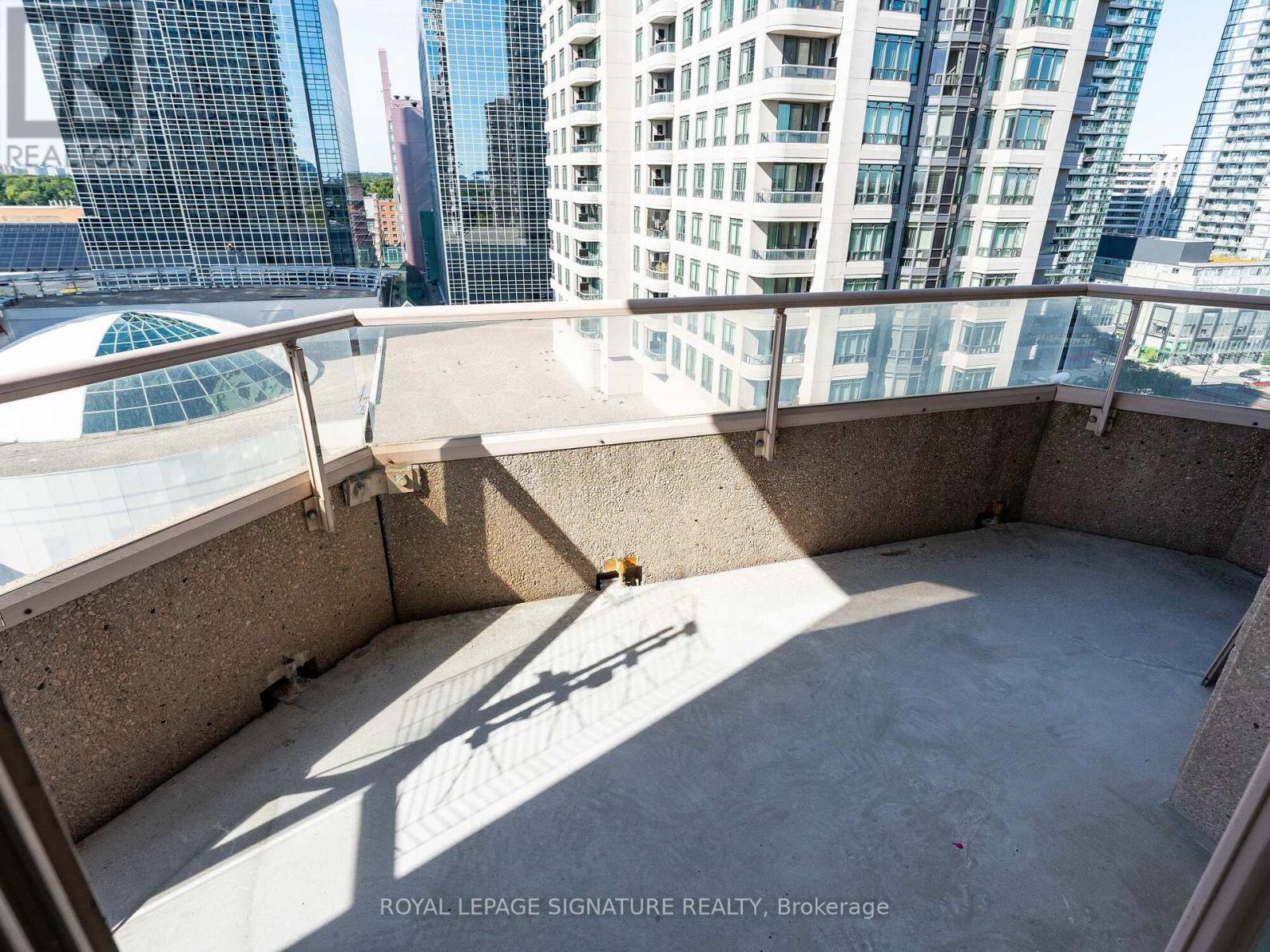 A balcony with a pool table and a view of the city.