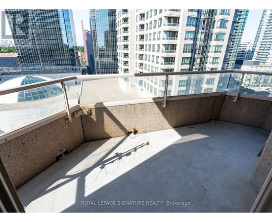 A balcony with a pool table and a view of the city.