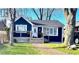 A blue house with a white door and windows.