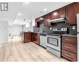 A modern kitchen with wooden cabinets and stainless steel appliances.