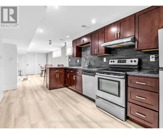 A modern kitchen with wooden cabinets and stainless steel appliances.