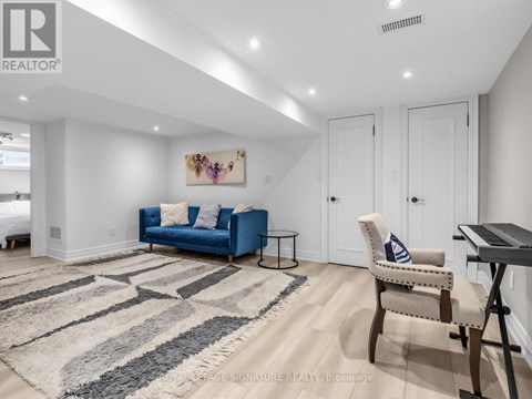 A living room with a blue couch and a rug.