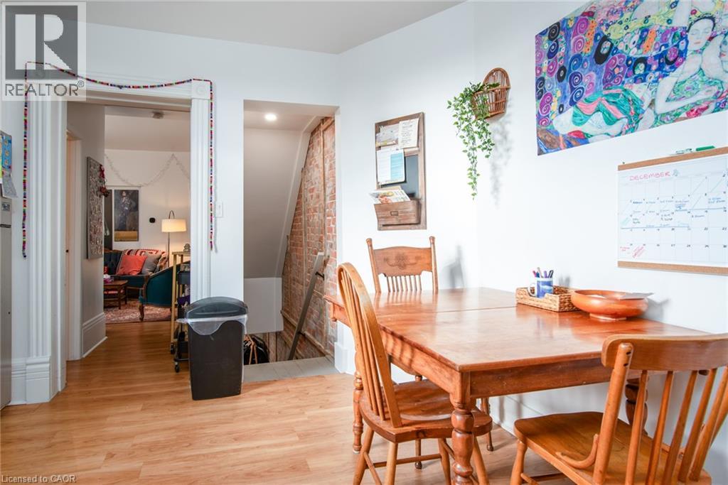 A dining room with a wooden table and chairs.