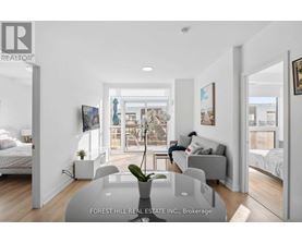 A real estate listing image of a modern bedroom with a glass table and two beds.
