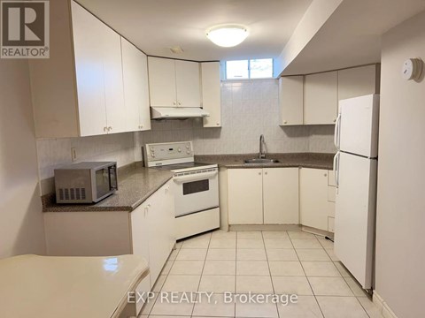 A kitchen with white cabinets and appliances is on the market.