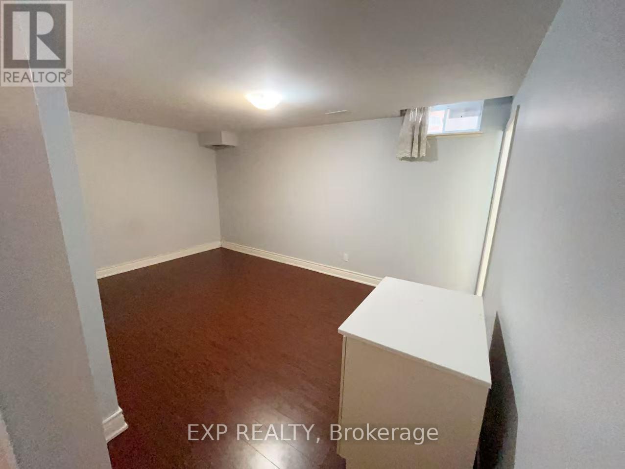 A room with EXP REALTY, Brokerage written on the bottom.