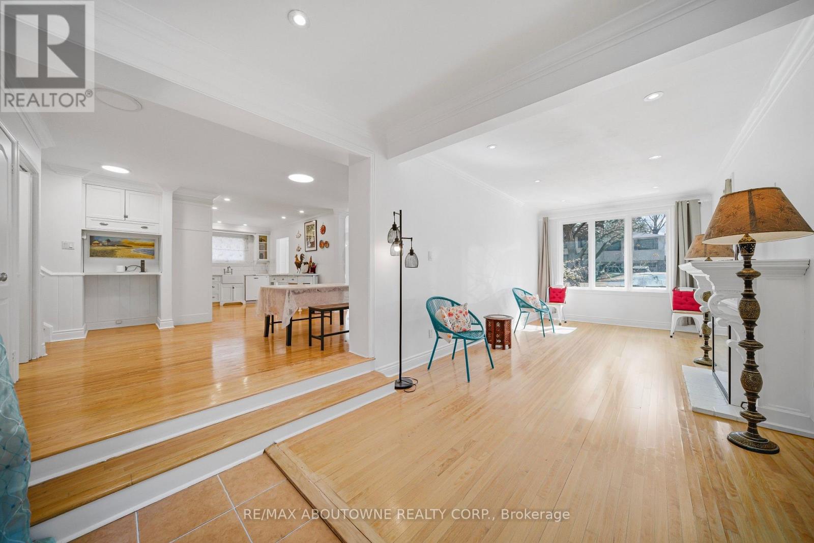 A spacious room with wooden floors and white walls.