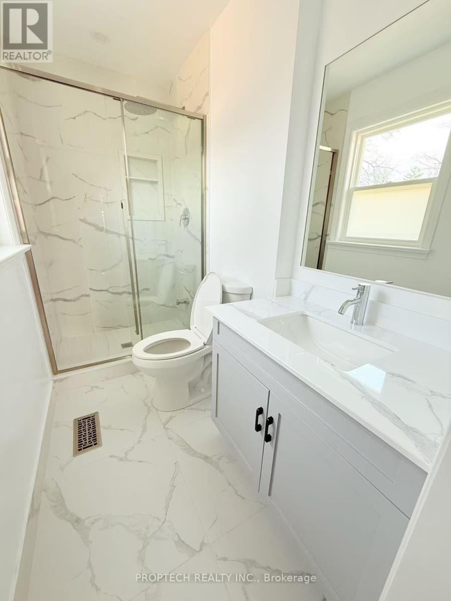 A white bathroom with a walk in shower.