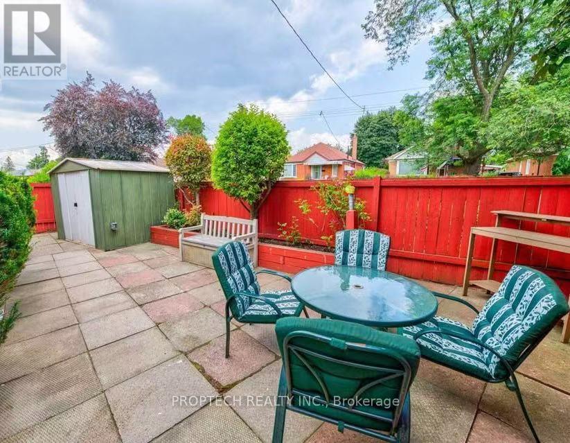 A backyard with a table and chairs.
