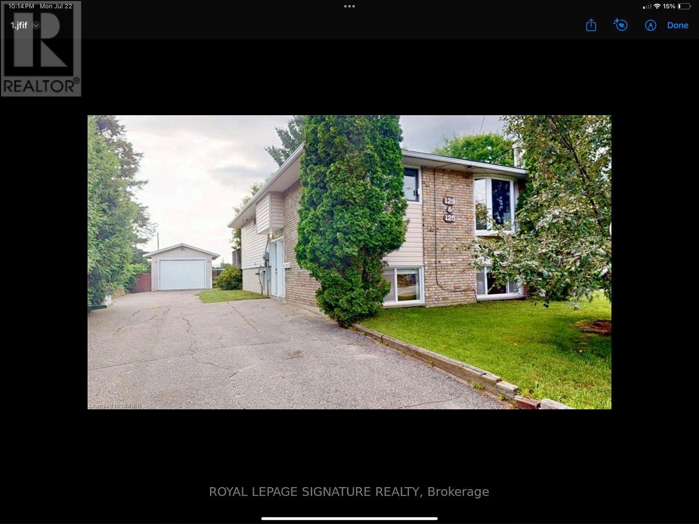 A house with a driveway and a sign that says Royal LePage Signature Realty, Brokerage.