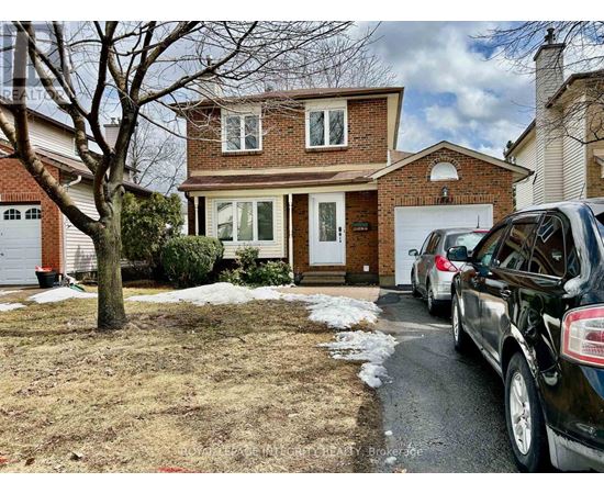 A house with a tree in front and cars parked in the driveway.