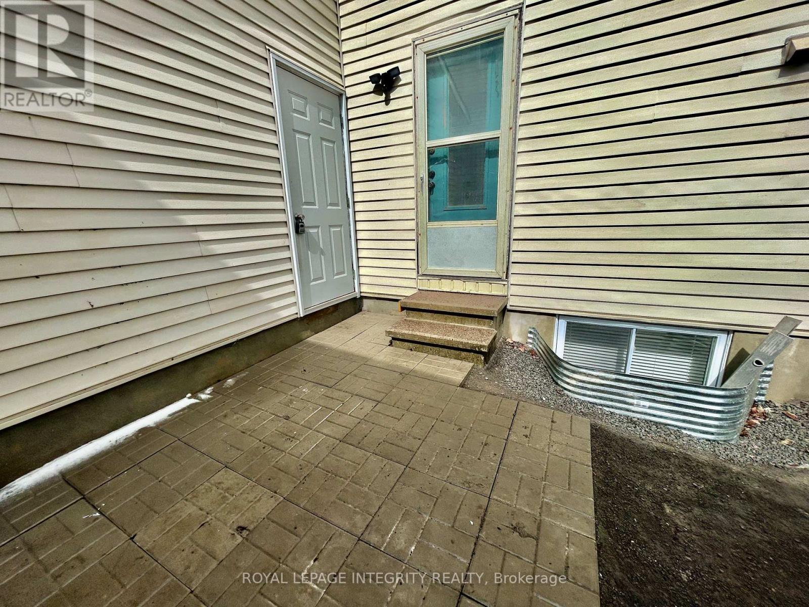 A small patio area with a door and a window.