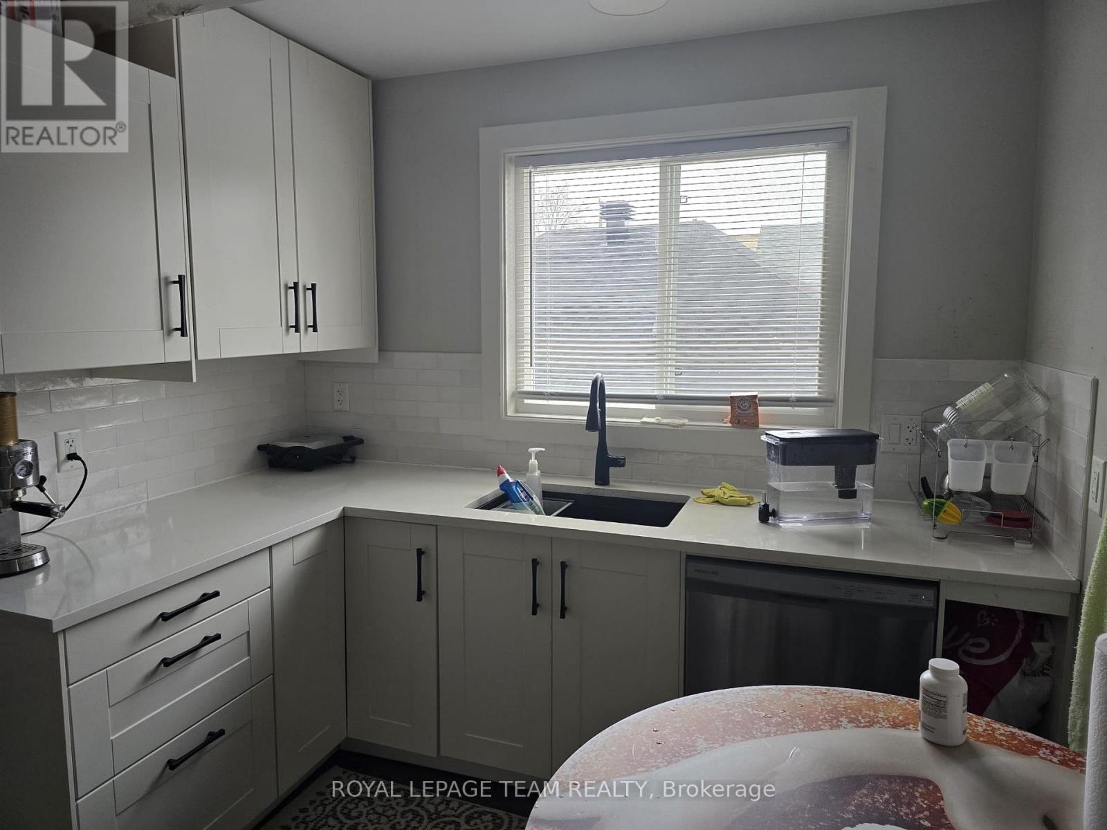 A bedroom with a bed, desk, and chair.