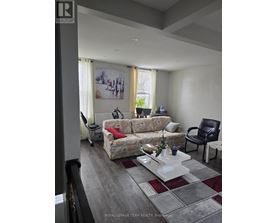 A living room with a couch, chair, and coffee table.