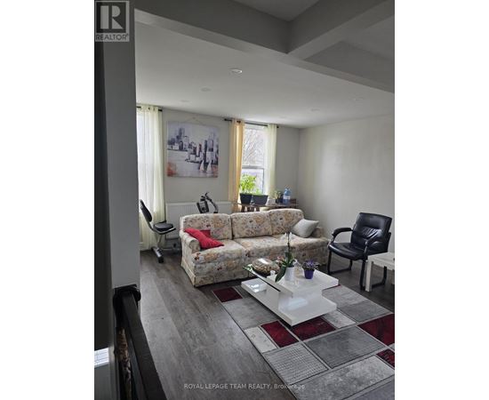 A living room with a couch, chair, and coffee table.