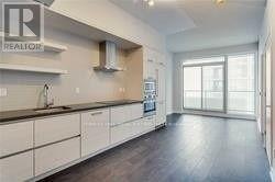 A realtor sign is on the wall above a kitchen counter.