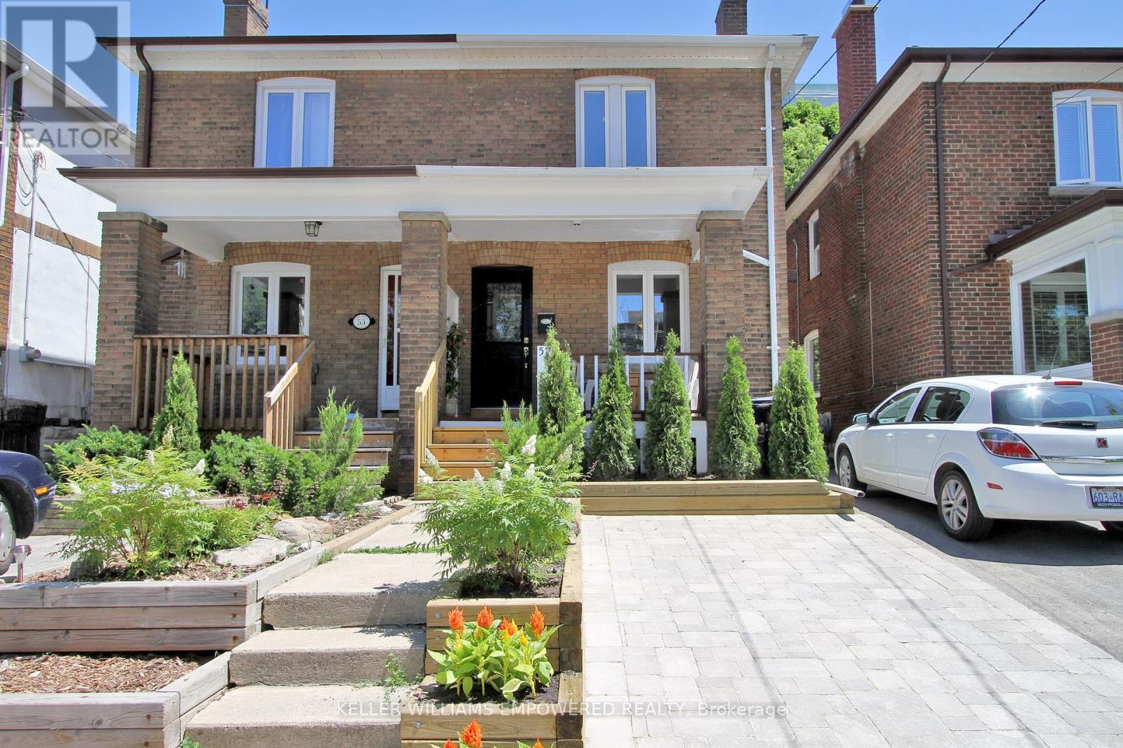 A house with a white car parked in front.