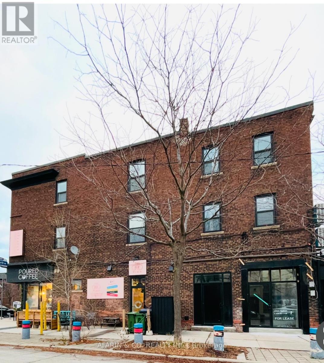 A brick building with a tree in front of it.