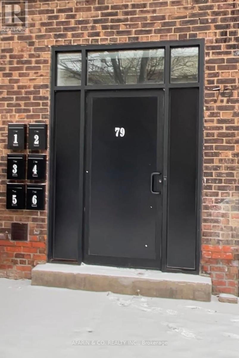 A black door with the number 79 on it.