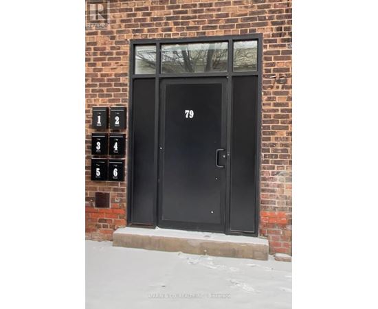 A black door with the number 79 on it.