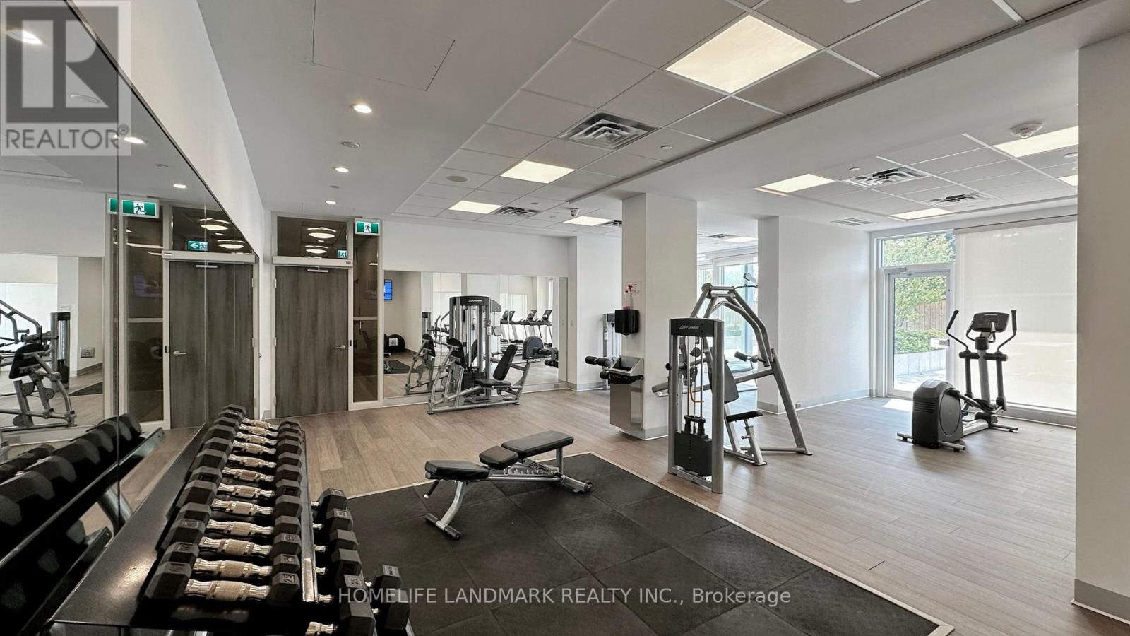 A gym with a variety of equipment including treadmills, weights, and exercise machines.