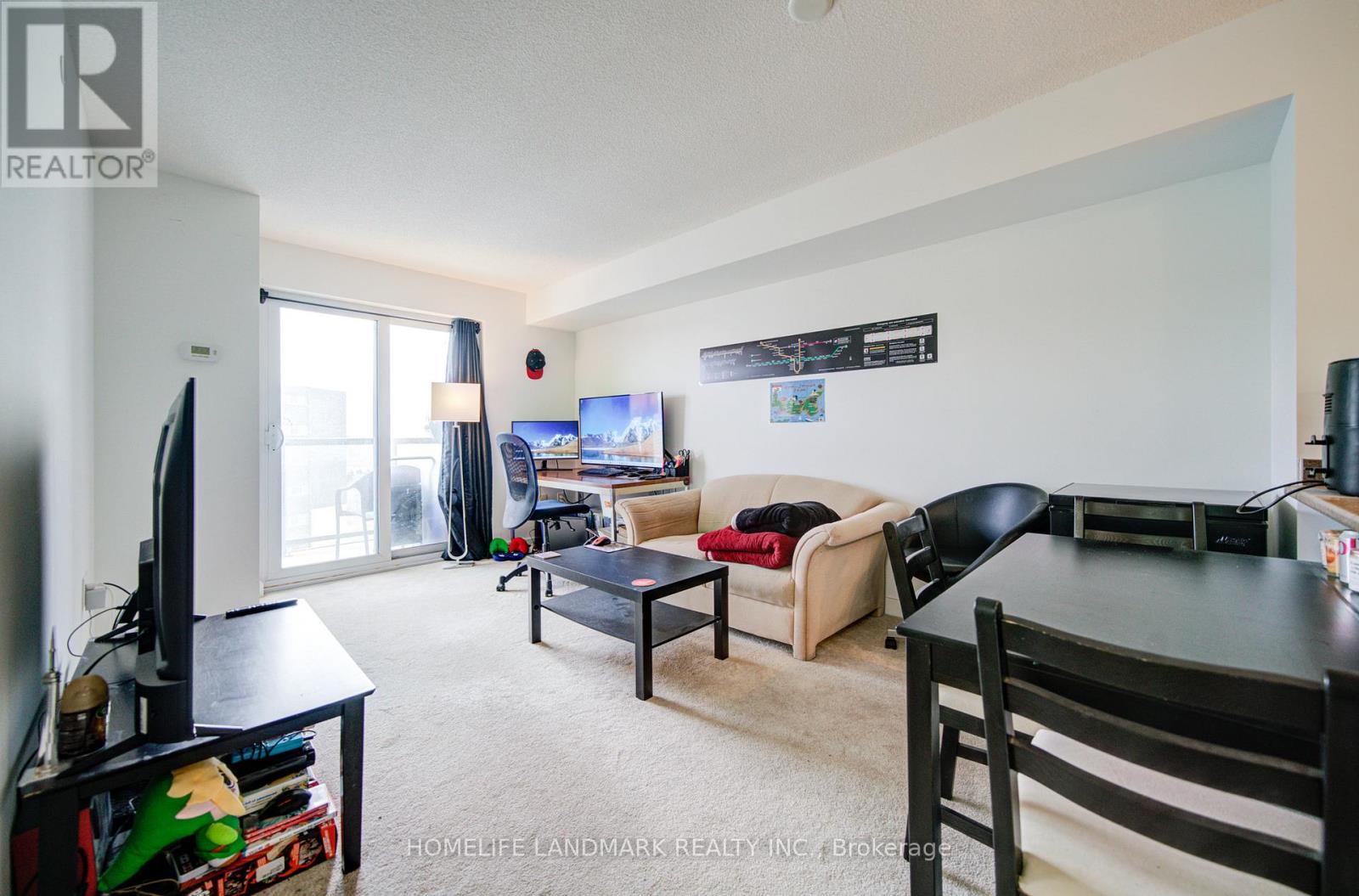 A living room with a couch, chair, and television.
