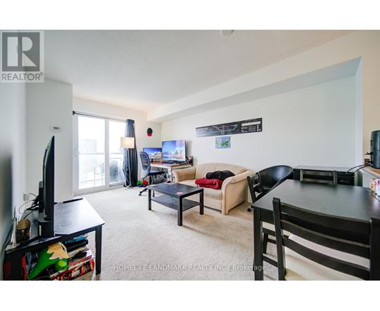 A living room with a couch, chair, and television.