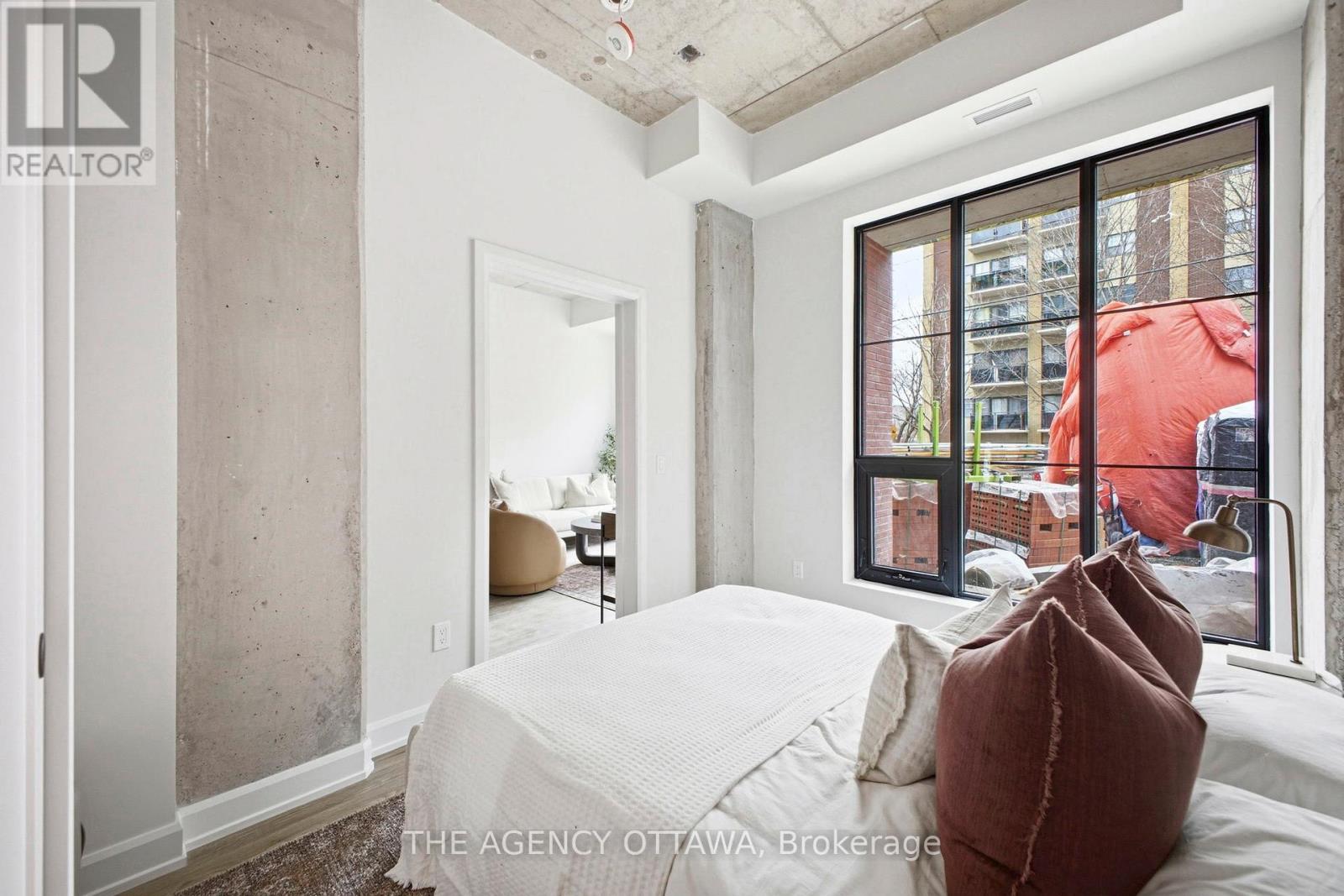 A bedroom with a large bed and a view of the city.