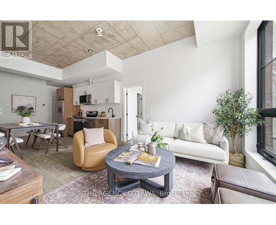 A living room with a grey coffee table and a white couch.